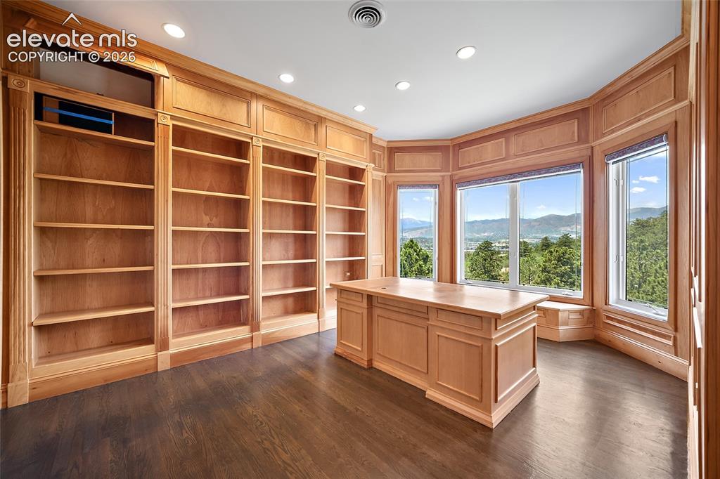 Image 23 of 50: Room featuring extensive built-in light wood cabinetry and shelving