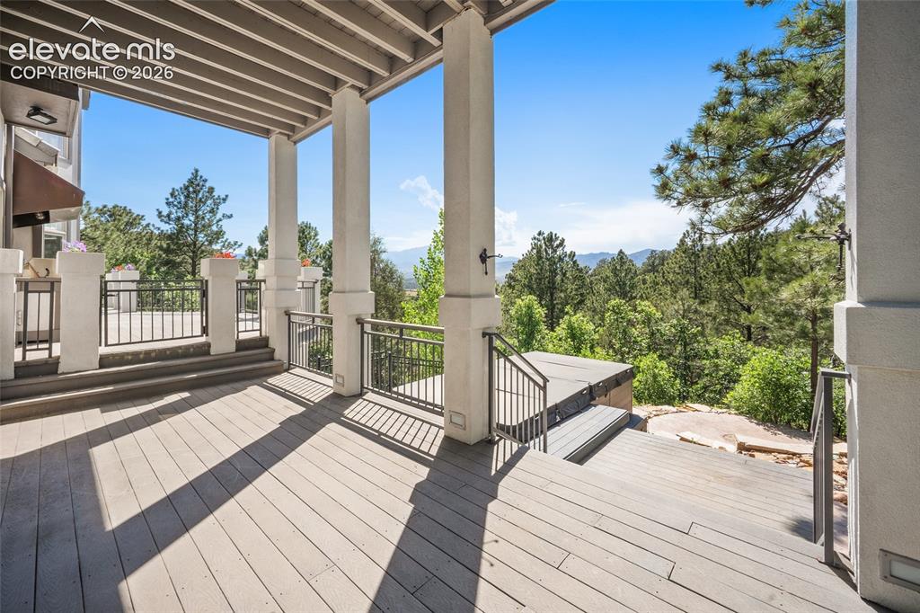 Image 38 of 50: Expansive covered deck featuring composite wood-finish flooring, substantia