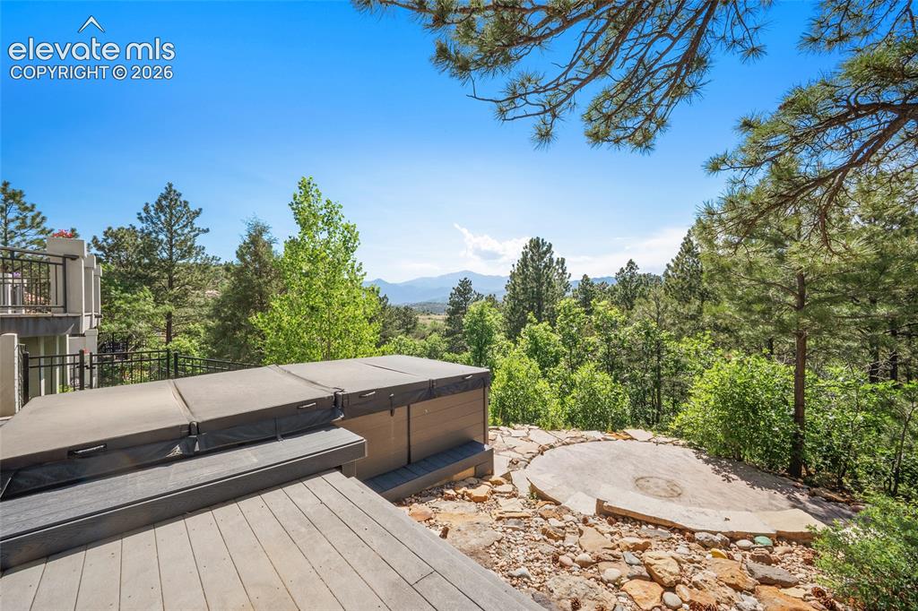 Image 40 of 50: Outdoor spa area featuring a built-in swimspa, composite decking, and a sto
