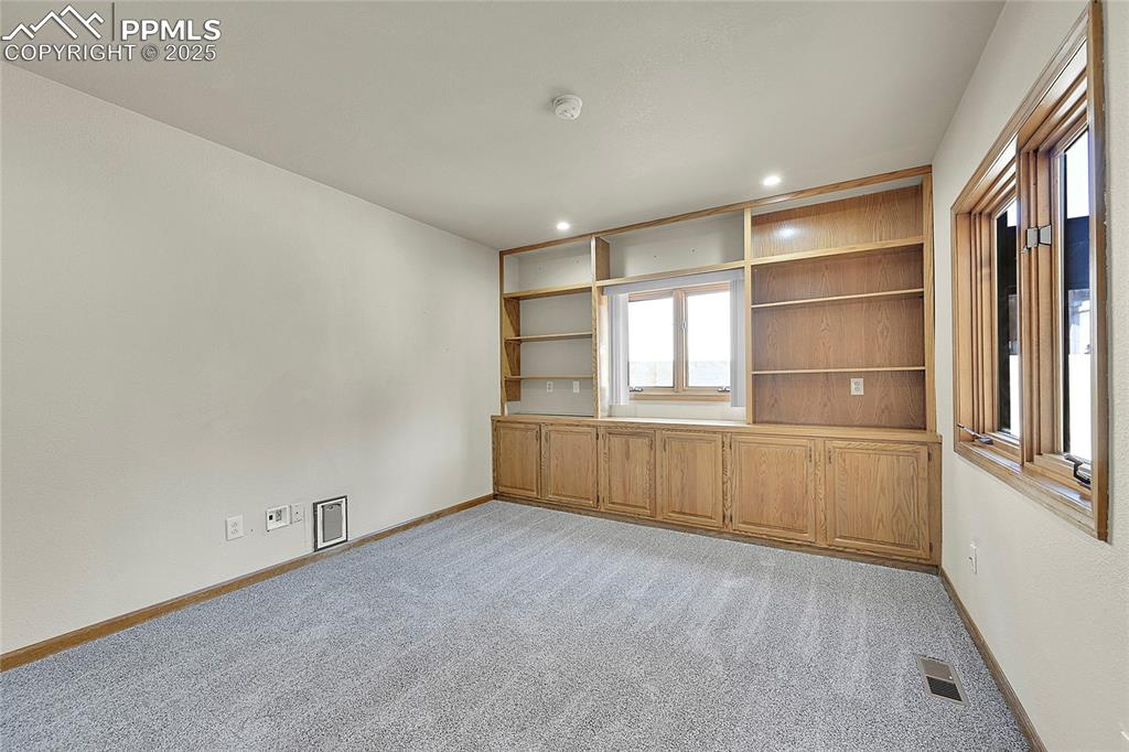 Image 16 of 30: Unfurnished room with light colored carpet, recessed lighting, and built in