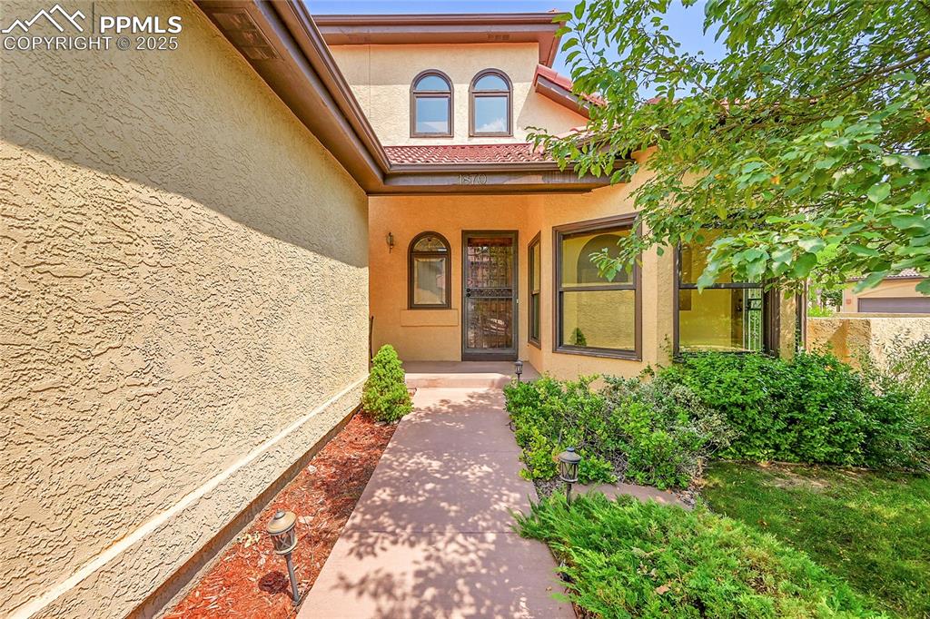 Image 5 of 30: Property entrance with stucco siding