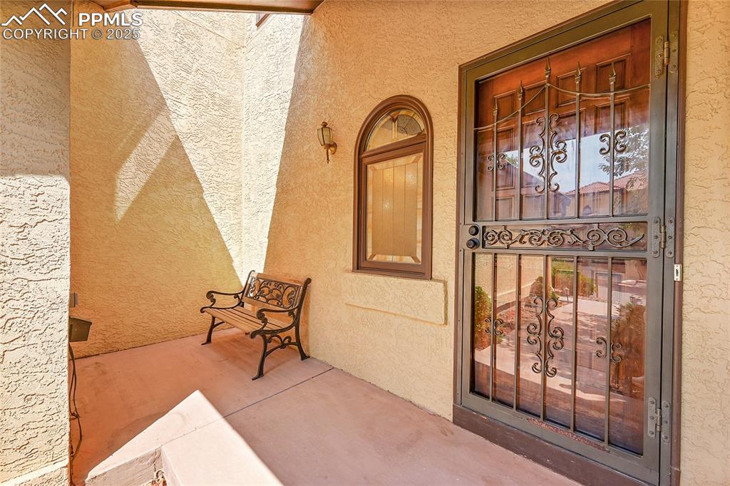 Image 6 of 30: View of exterior entry featuring stucco siding