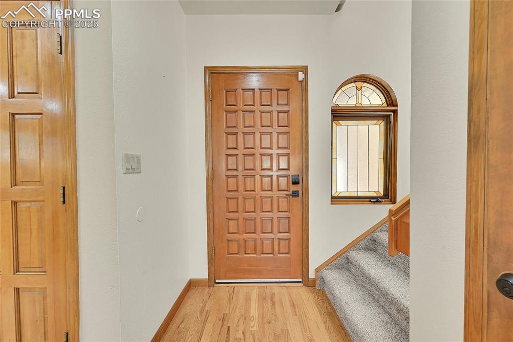 Image 7 of 30: Foyer entrance with light wood-type flooring and stairway
