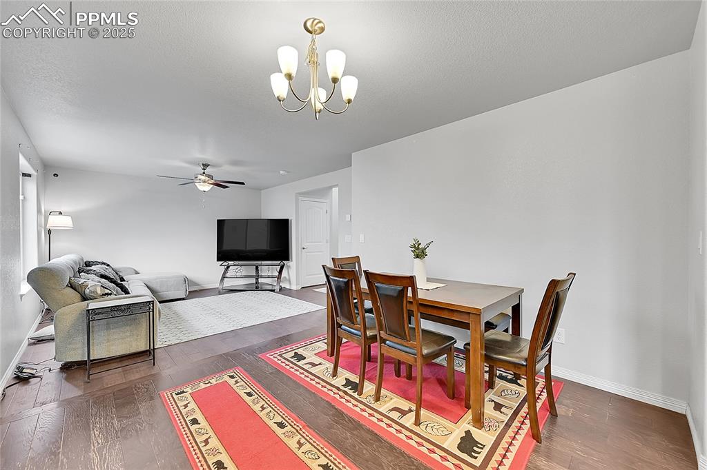 Image 11 of 29: Dining area featuring baseboards, ceiling fan with notable chandelier, and