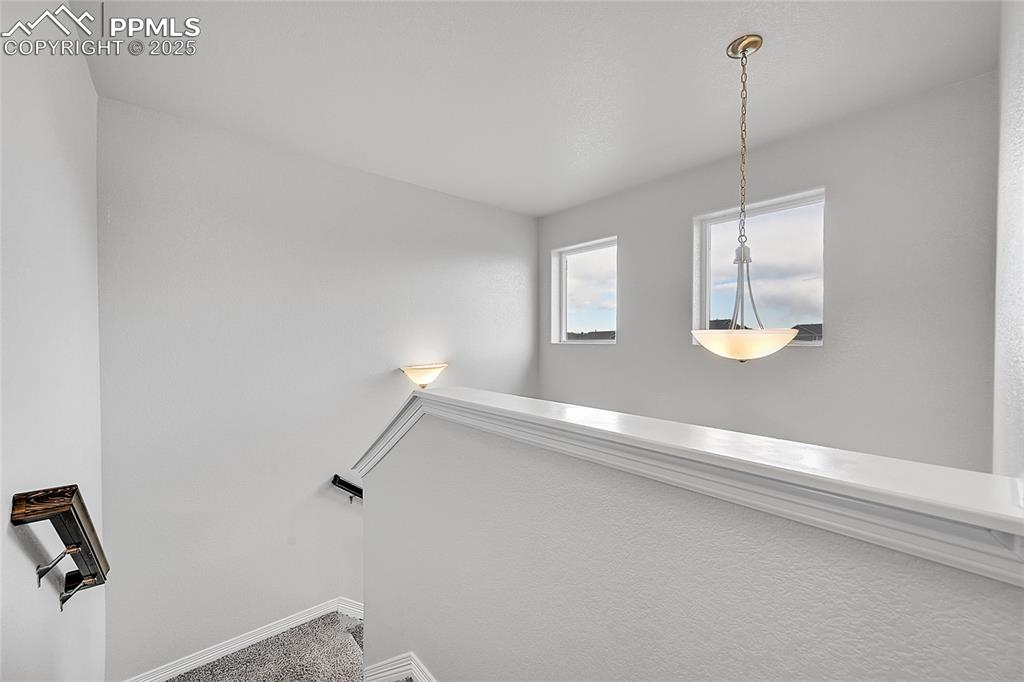 Image 19 of 29: Staircase with baseboards and carpet flooring