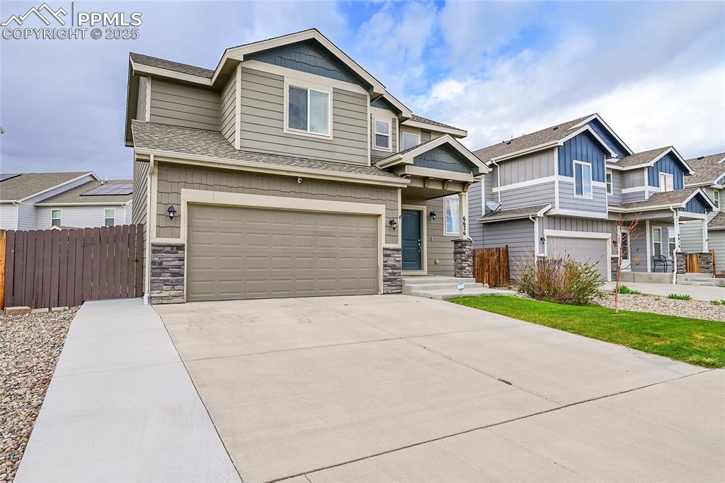 Image 2 of 29: Craftsman house featuring fence, a shingled roof, stone siding, a garage, a