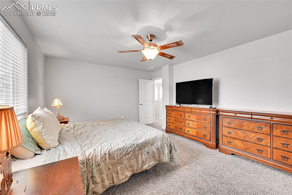 Image 21 of 29: Bedroom featuring carpet floors and a ceiling fan