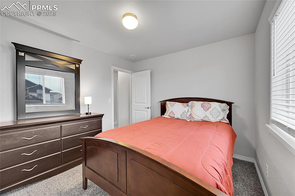 Image 25 of 29: Bedroom featuring baseboards and light colored carpet