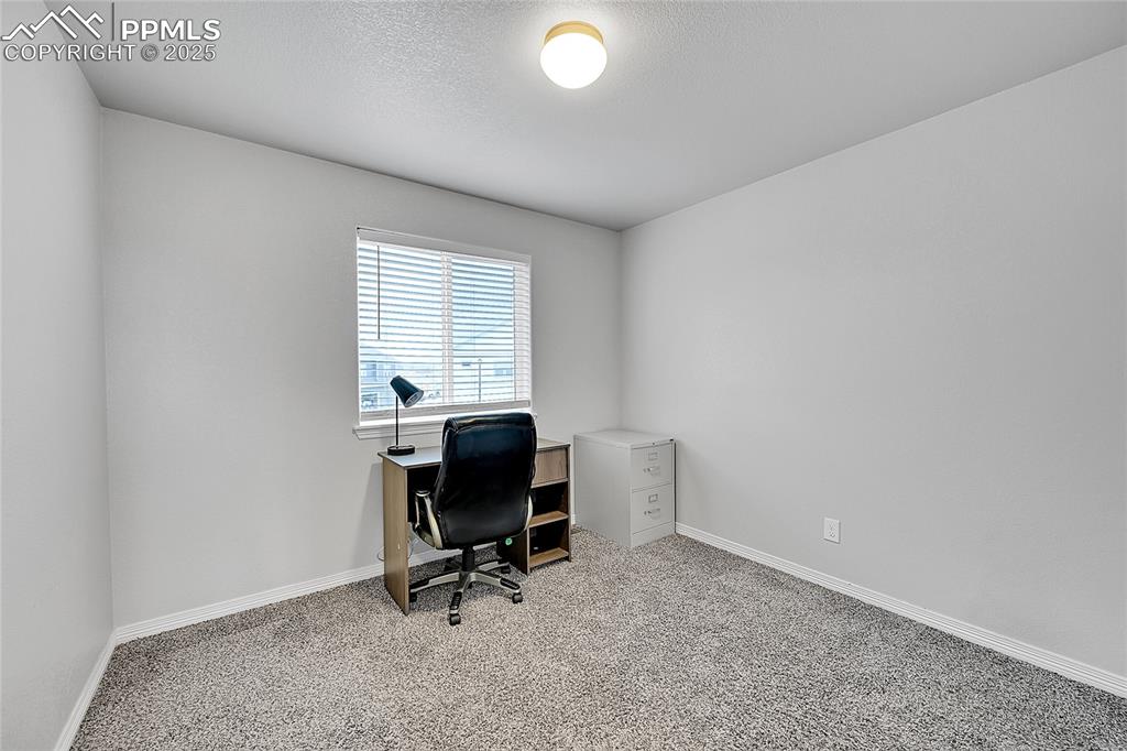 Image 27 of 29: Office space featuring baseboards, light carpet, and a textured ceiling