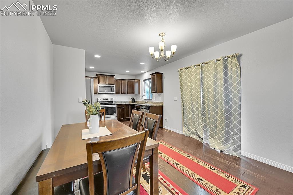 Image 9 of 29: Dining area featuring recessed lighting, baseboards, dark wood-style floors