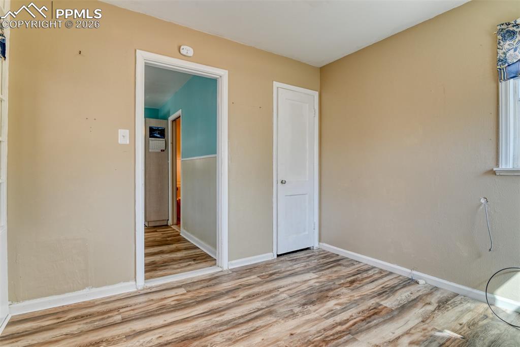 Image 12 of 47: Spare room featuring baseboards and wood finished floors