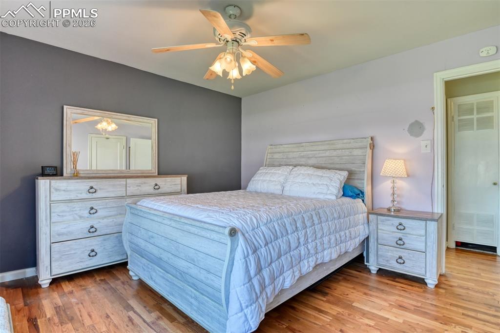 Image 15 of 47: Bedroom with ceiling fan and wood finished floors