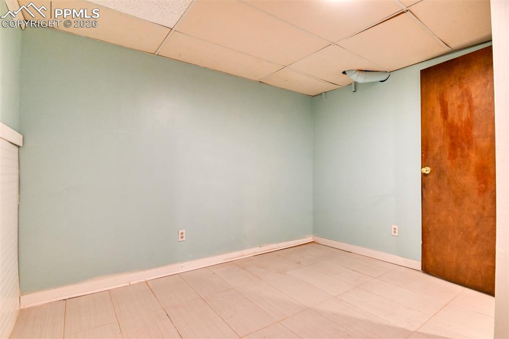 Image 29 of 47: Unfurnished room featuring baseboards and a paneled ceiling
