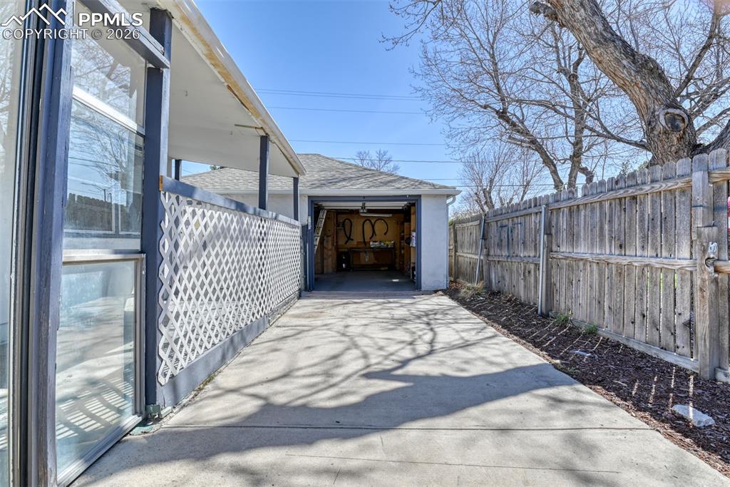 Image 34 of 47: View of patio / terrace with an outdoor structure and fence