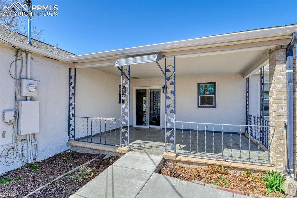Image 39 of 47: View of exterior entry with a patio area and stucco siding