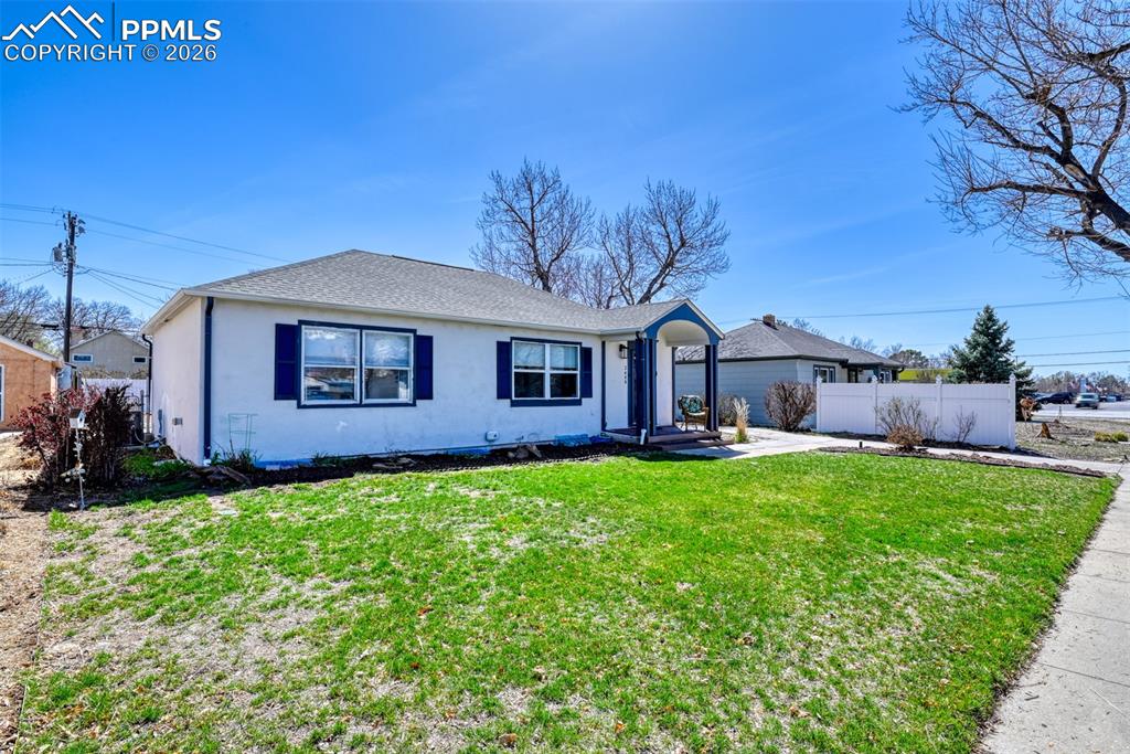 Image 46 of 47: Single story home with roof with shingles, stucco siding, fence, and a fron