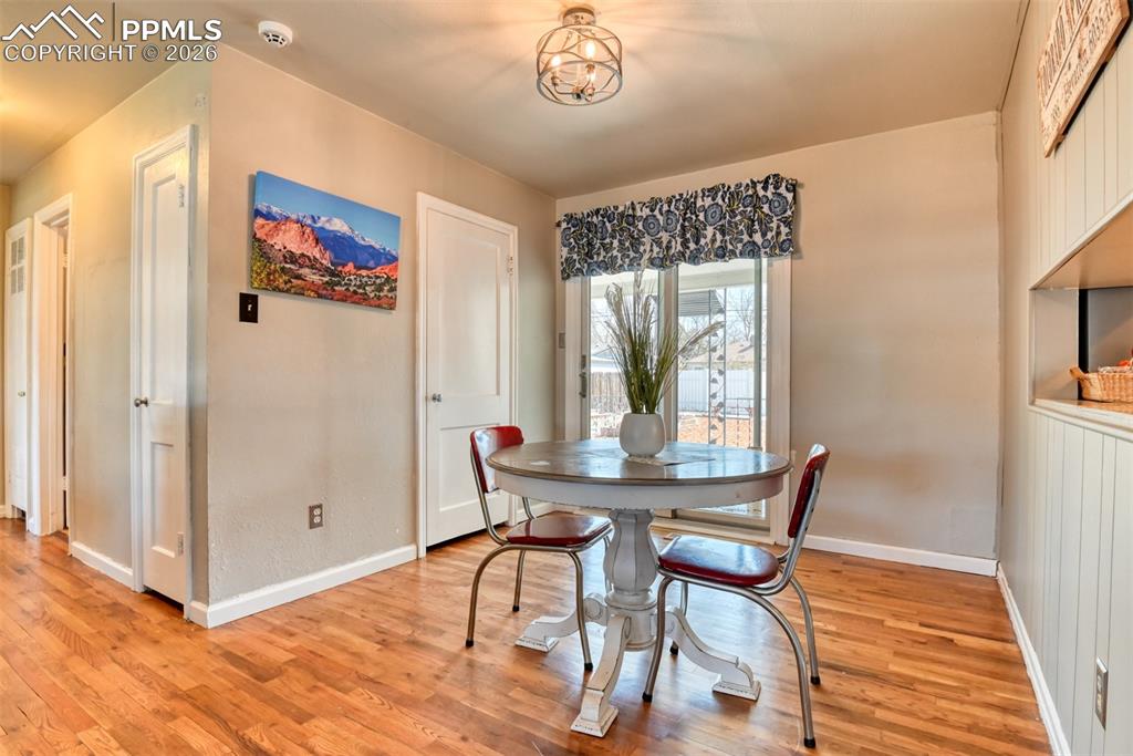 Image 5 of 47: Dining room featuring light wood-style flooring, an inviting chandelier, an