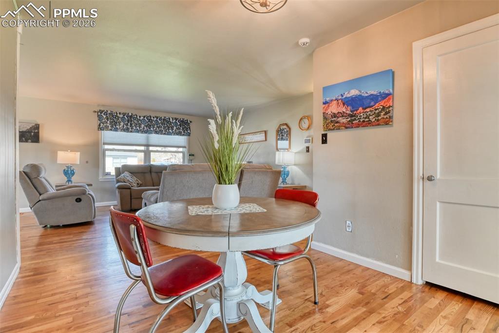 Image 7 of 47: Dining room with baseboards and light wood-style floors