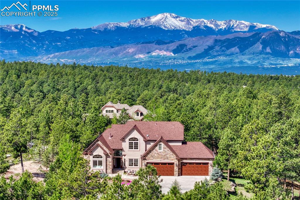 Caption: A stunning 2.91 acre home in the trees and a view and 4 car garage