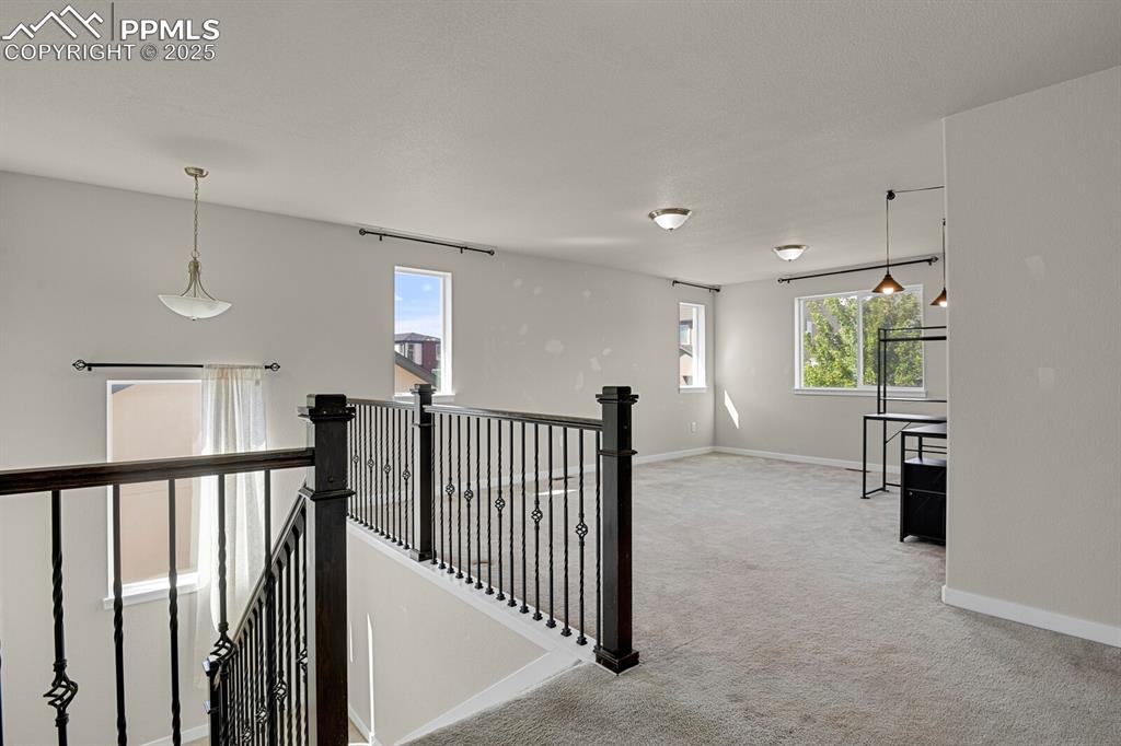 Image 14 of 31: Hallway with an upstairs landing and light colored carpet
