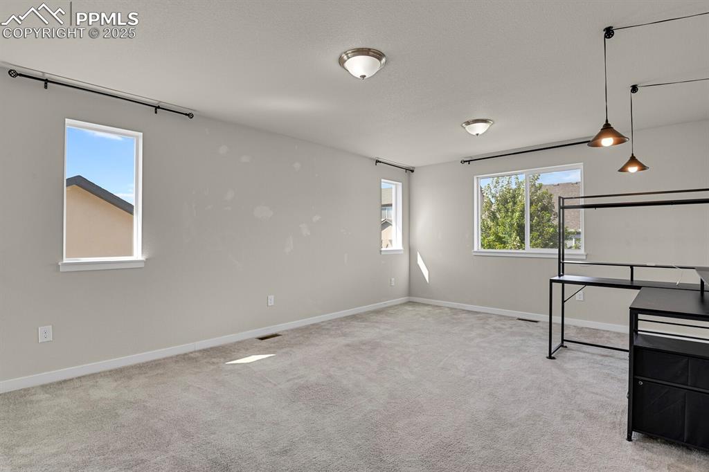 Image 15 of 31: Basement with light carpet and baseboards
