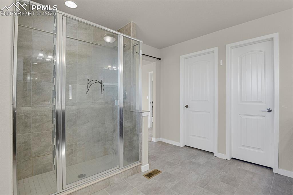 Image 20 of 31: Full bathroom with a stall shower and baseboards