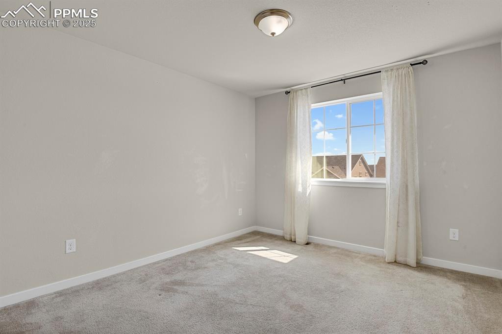 Image 23 of 31: Carpeted empty room with baseboards