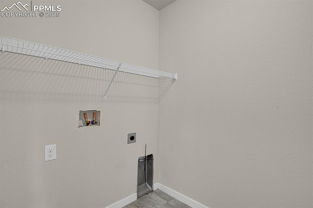 Image 24 of 31: Washroom with hookup for a washing machine, hookup for an electric dryer, a