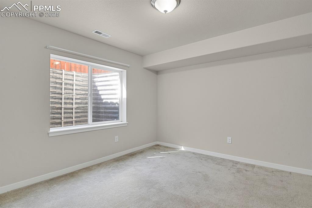 Image 28 of 31: Carpeted spare room featuring baseboards and a textured ceiling