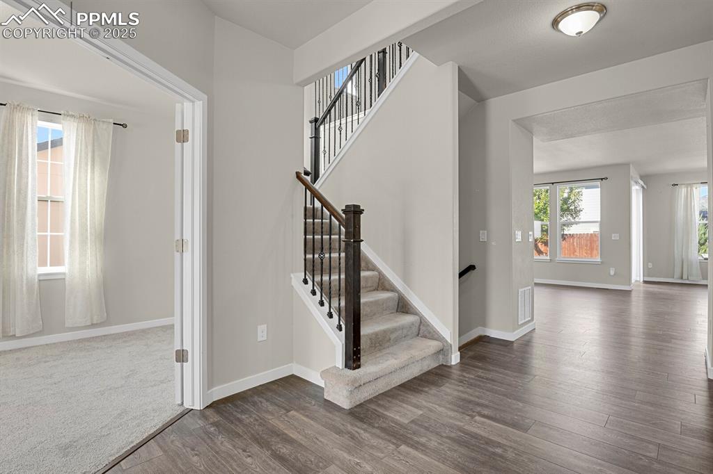 Image 3 of 31: Stairway with baseboards and wood finished floors
