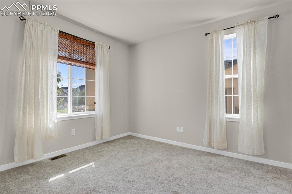 Image 4 of 31: Unfurnished room with carpet and baseboards