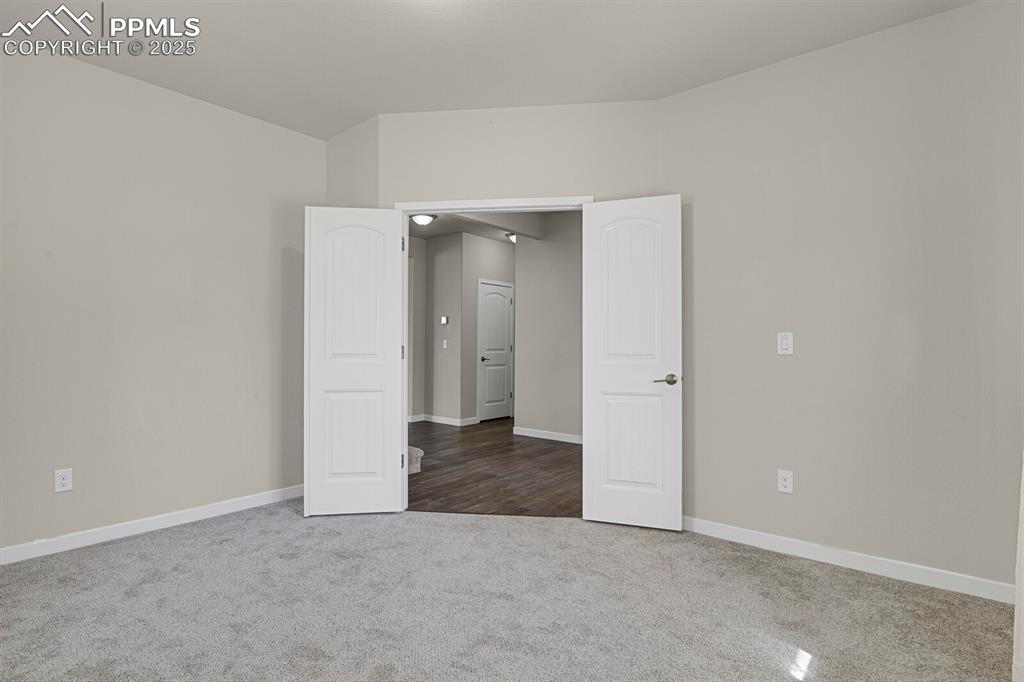 Image 5 of 31: Spare room featuring carpet floors and baseboards