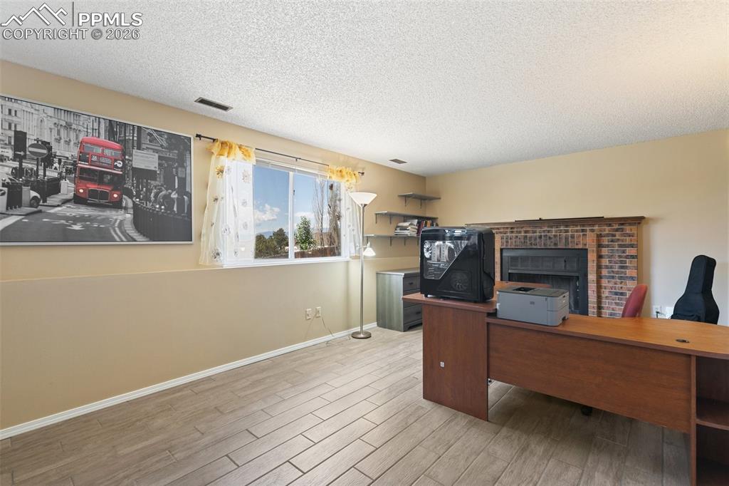 Image 18 of 41: Cozy family room with wood-burning fireplace