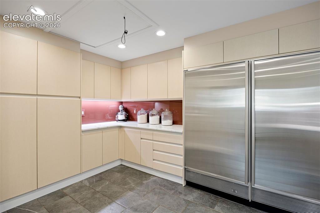 Image 10 of 36: A separate scullery with commercial fridge/freezer adds space to prep and s