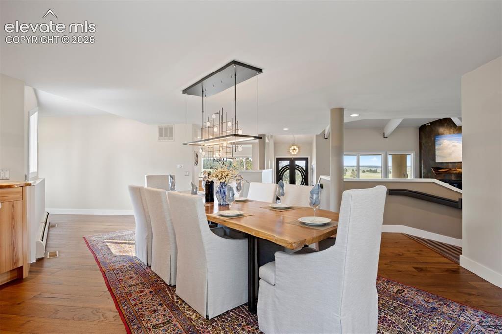 Image 12 of 36: Formal dining area adjacent to the kitchen, featuring a spacious layout, a