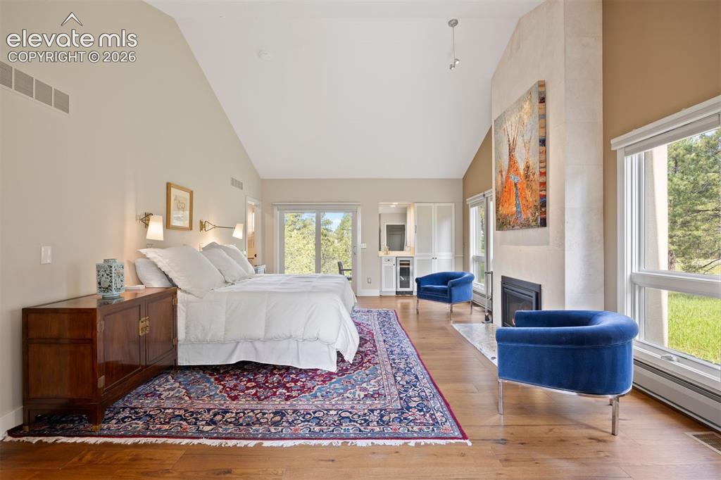 Image 13 of 36: Vaulted primary bedroom with it