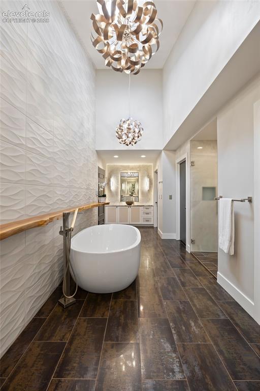 Image 15 of 36: Primary bathroom with heated floors and dual entries, each leading to priva