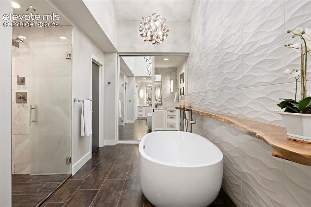 Image 16 of 36: Two private water closets and a walk-in shower with five shower heads inclu