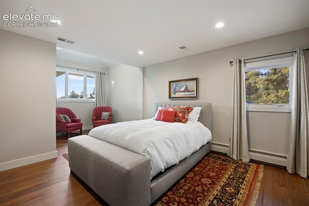 Image 21 of 36: Upstairs bedroom with sitting area and private ensuite.