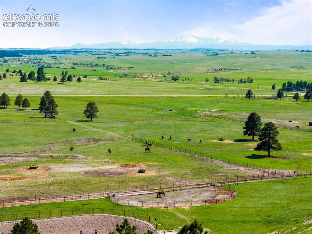 Image 30 of 36: View of the pastures with Pikes Peak in the distance.