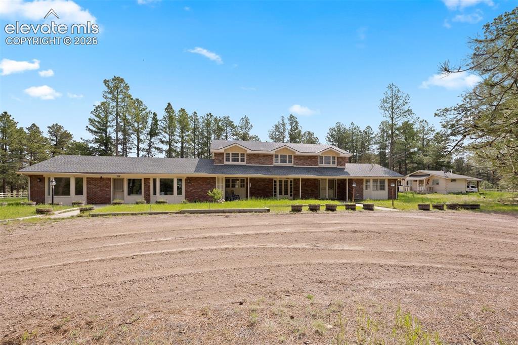 Image 31 of 36: Separate guest house and log cabin caretakers quarters.