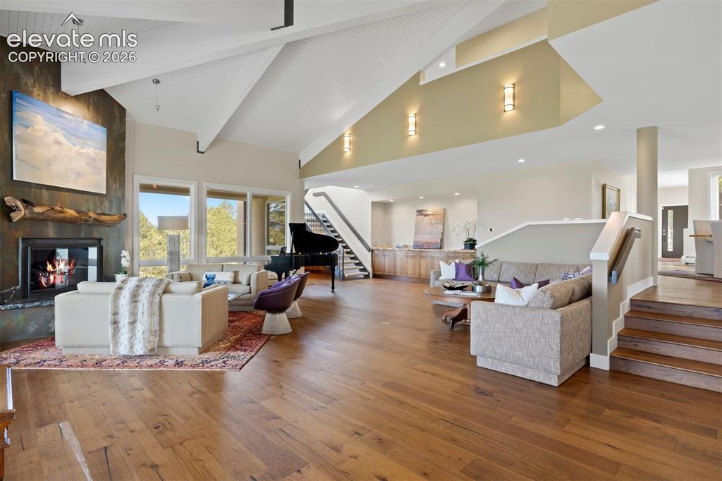 Image 6 of 36: The great room feature built-in storage and an under-stair sitting nook.