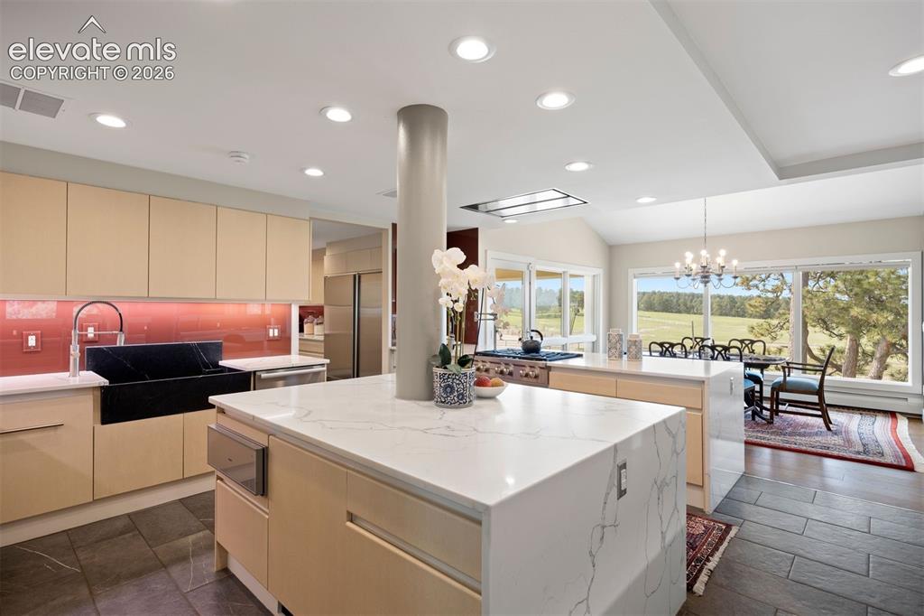 Image 8 of 36: Premium Wolf and Sub-Zero appliances, including two oversized refrigerators