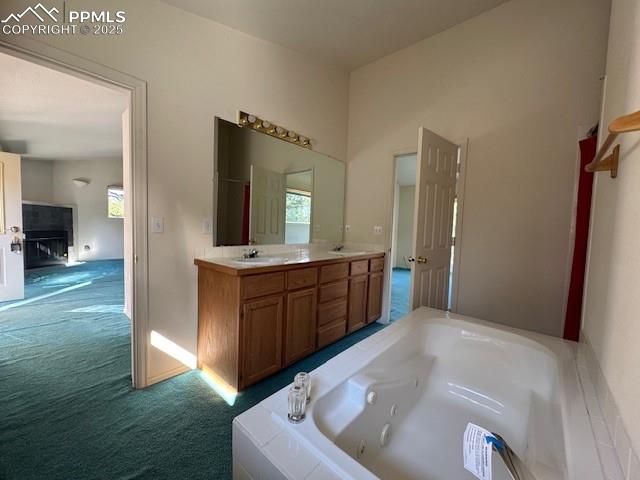 Image 11 of 19: Bathroom with a jetted tub, double vanity, and plenty of natural light