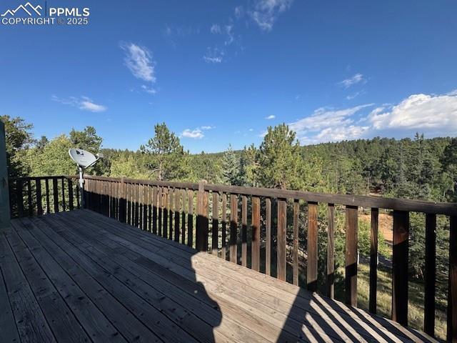 Image 17 of 19: Deck with a wooded view