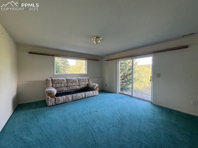 Image 6 of 19: Carpeted living room featuring baseboards