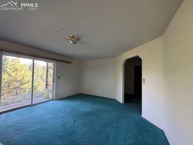 Image 7 of 19: Unfurnished room featuring arched walkways and carpet floors