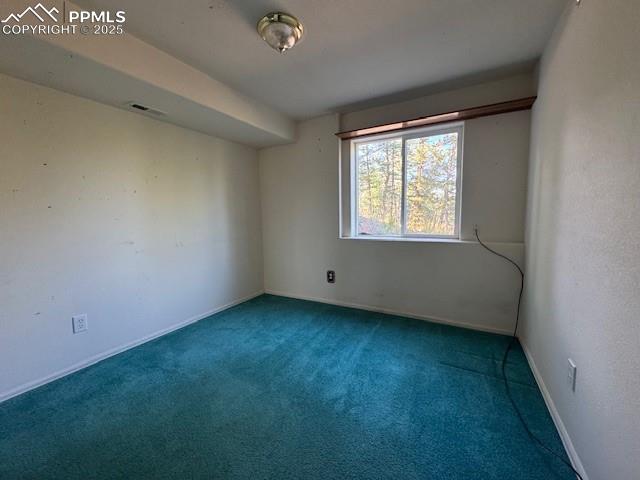 Image 8 of 19: Carpeted spare room with baseboards
