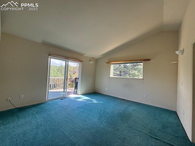 Image 9 of 19: Spare room with vaulted ceiling and carpet flooring