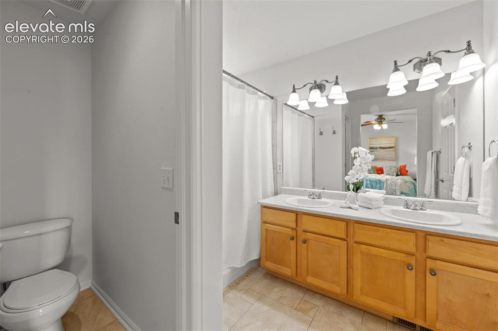 Image 15 of 31: Dual vanity and separate commode room